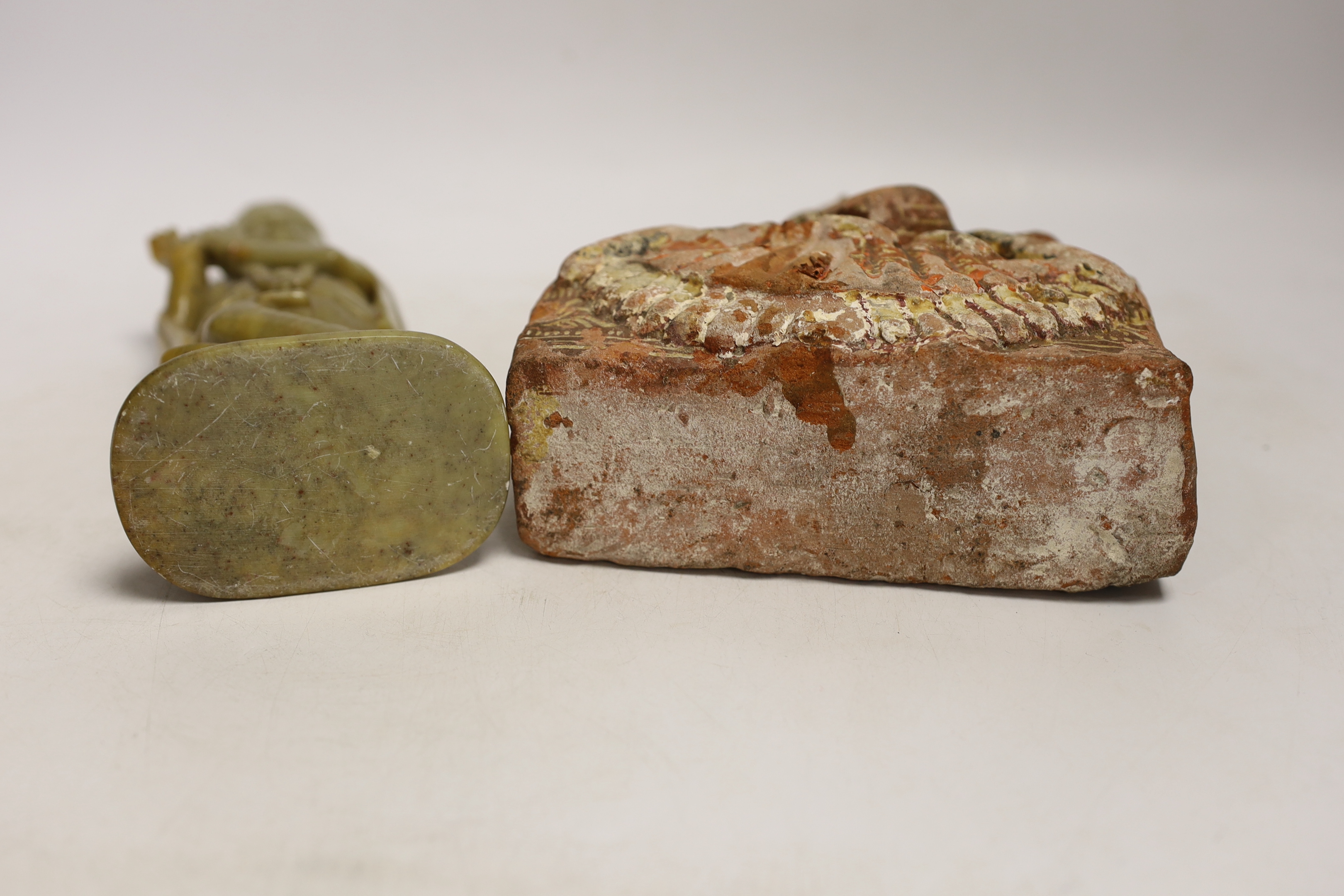 An Indian soapstone carved figure of Krishna and a terracotta figure of Saraswati, tallest 23cm